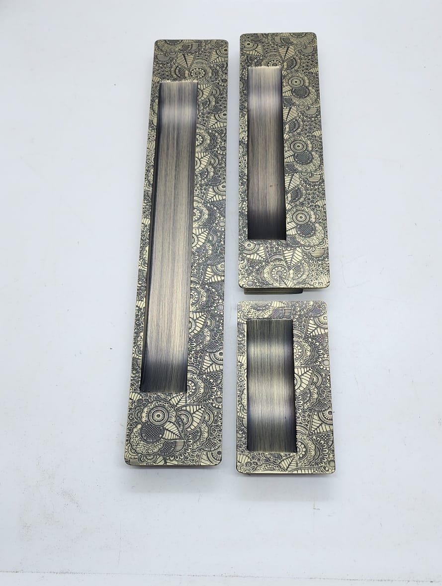 Three sizes of etched mehndi-pattern recessed flush pull handles for sliding doors in antique brass
